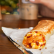 Taco Bell breakfast burrito on wooden table